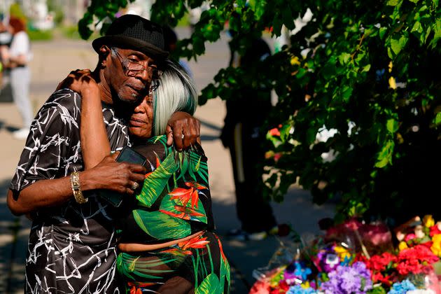 People embrace outside the scene of a shooting at a supermarket a day earlier, in Buffalo on Sunday. (Photo: via Associated Press)