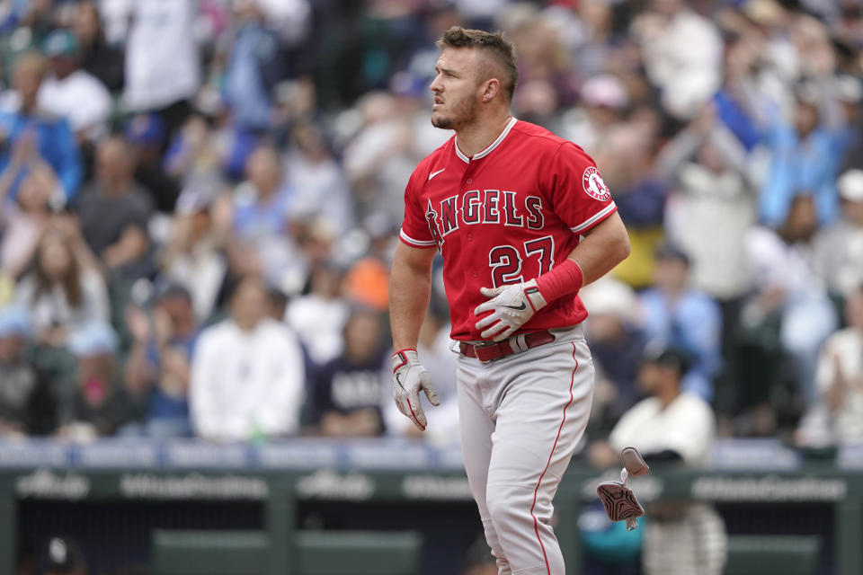 Los Angeles Angels' Mike Trout looks toward the outfield after he struck out swinging to end the top of the seventh inning of the first baseball game of a doubleheader against the Seattle Mariners, Saturday, June 18, 2022, in Seattle. (AP Photo/Ted S. Warren)