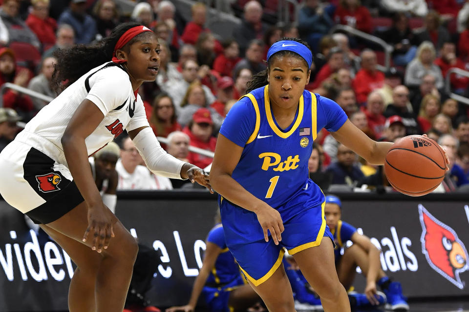 Pittsburgh guard Dayshanette Harris (1) drives around Louisville guard Elizabeth Balogun (4) during the first half of an NCAA college basketball game in Louisville, Ky., Sunday, Jan. 26, 2020. (AP Photo/Timothy D. Easley)