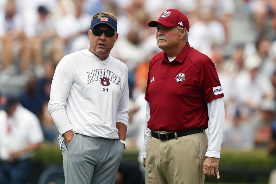 Auburn head coach Hugh Freeze, left, talks with Massachusetts head coach Don Brown before an NCAA college football game Saturday, Sept. 2, 2023, in Auburn, Ala. (AP Photo/Butch Dill)