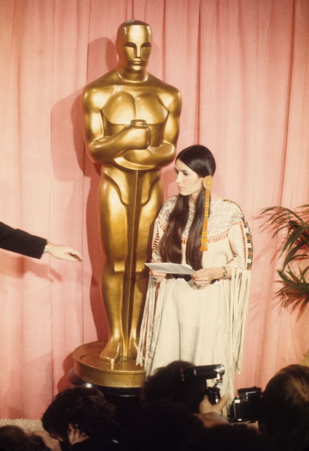 March 27 - LOS ANGELES: Sacheen Littlefeather (born Marie Louise Cruz, 1946 - 2022) holds a written statement from actor Marlon Brando refusing his Best Actor Oscar on stage at the <a href="https://parade.com/movies/oscars-2023-academy-awards" rel="nofollow noopener" target="_blank" data-ylk="slk:Academy Awards;elm:context_link;itc:0;sec:content-canvas" class="link ">Academy Awards</a> on March 27, 1973 in Los Angeles, California. (Photo by Michael Ochs Archvies/Getty Images)<p><a href="https://www.gettyimages.com/detail/176795032" rel="nofollow noopener" target="_blank" data-ylk="slk:Michael Ochs Archives/Getty Images;elm:context_link;itc:0;sec:content-canvas" class="link ">Michael Ochs Archives/Getty Images</a></p>