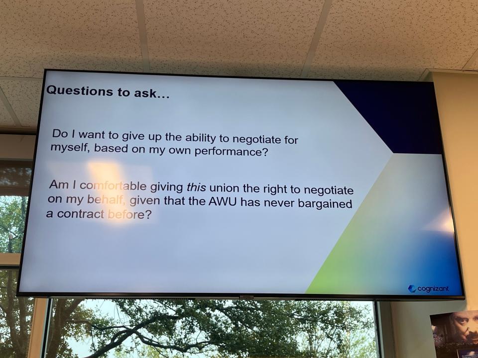 Photo of a TV screen in Cognizant's office. The screen displays questions workers should ask a union before deciding to vote in favor or against.