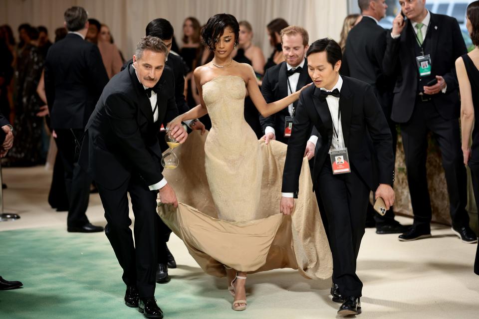 Tyla gets help carrying her dress at the 2024 Met Gala.