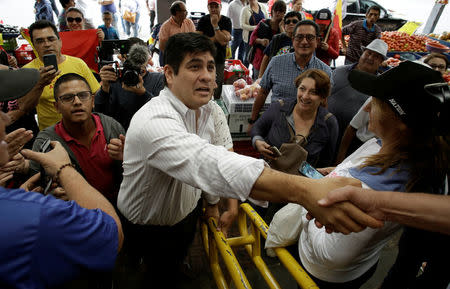 Carlos Alvarado Quesada, presidential candidate of the ruling Citizens' Action Party (PAC), greets people as he visits a market before a second-round presidential election run-off in Cartago, Costa Rica, March 31, 2018. REUTERS/Juan Carlos Ulate