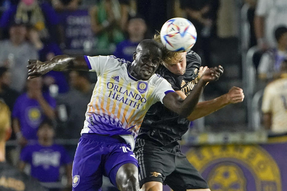 FILE -Orlando City's Benji Michel, left, and Arsenal's Rob Holding try to get control of a head ball during the second half of a Florida Cup friendly soccer match Wednesday, July 20, 2022, in Orlando, Fla. Orlando City’s pursuit of its first trophy in the U.S. Open Cup is personal for Benji Michel, who grew up in Orlando and was signed by the Lions as a homegrown player. (AP Photo/John Raoux, File)