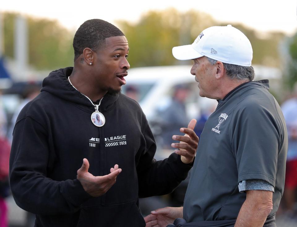 Ohio State running back DeaMonte Trayanum catches up with a member of the Hoban coaching staff before a game Friday against Walsh Jesuit in Akron.