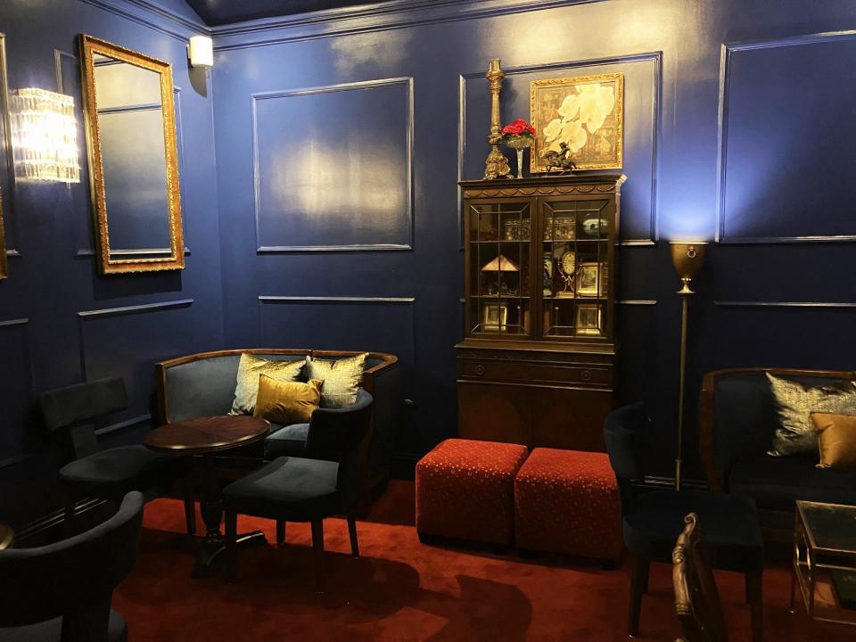 Visually striking, the Velvet Room with its royal blue walls, red carpet, chandeliers, banquettes, vintage chairs and gold frame paintings, is City Grille & Raw Bar's comfortable lounge.