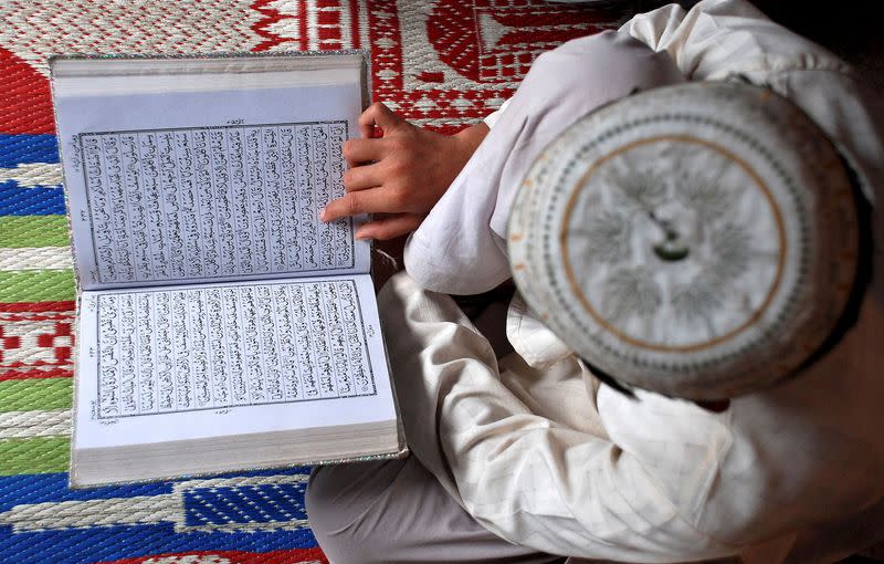 FILE PHOTO: FILE PHOTO: A Muslim boy reads the Koran at a madrasa in Mathura