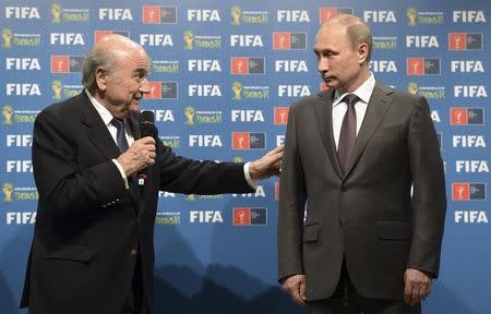 Russia's President Vladimir Putin (R) and FIFA President Sepp Blatter take part in the official hand over ceremony for the 2018 World Cup scheduled to take place in Russia, in Rio de Janeiro July 13, 2014. REUTERS/Alexey Nikolsky/RIA Novosti/Kremlin/Files