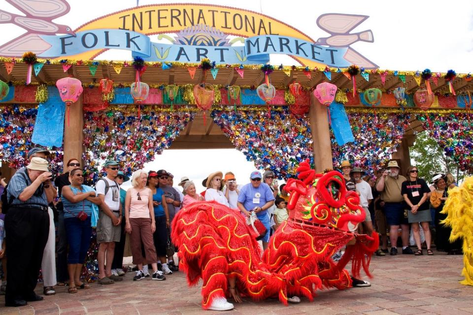 This 2008 photo provided by the Santa Fe International Folk Art Market shows Vietnamese Lion Dancers entertaining the crowd at the market in Santa Fe, N.M. The lion dancers will be back this year for the July 13-15 market. (AP Photo/Santa Fe International Folk Art Market, Bob Smith)