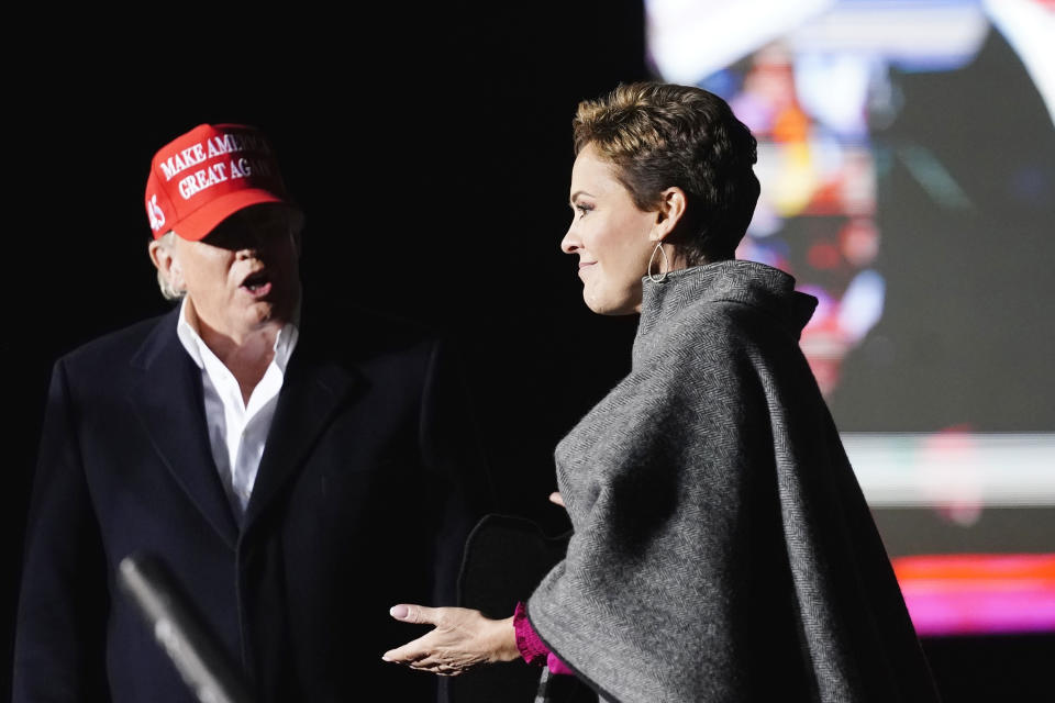 FILE - Former President Donald Trump, left, introduces Arizona Republican candidate for governor Kari Lake, right, as Trump speaks at a rally on Jan. 15, 2022, in Florence, Ariz. Former U.S. Rep. Matt Salmon dropped out of the race for the Republican nomination for Arizona governor on Tuesday, June 28, 2022, a move that comes a week before early ballots are mailed out and leaves just two top contenders in the GOP contest. Salmon was widely seen as trailing former TV news anchor Kari Lake and developer Karrin Taylor Robson. (AP Photo/Ross D. Franklin, File)