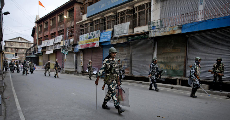 FILE-In this Aug. 9, 2019, file photo, Indian paramilitary soldiers patrol during curfew in Srinagar, Indian controlled Kashmir. The beautiful Himalayan valley is flooded with soldiers and roadblocks of razor wire. Phone lines are cut, internet connections switched off, politicians arrested. Narendra Modi, the prime minister of the world’s largest democracy has clamped down on Kashmir to near-totalitarian levels. (AP Photo/ Dar Yasin, file)