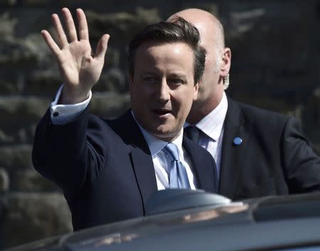 Britain's Prime Minsiter David Cameron waves as he leaves after launching the Conservative Party's election manifesto in Swindon, western England, April 14, 2015. REUTERS/Toby Melville