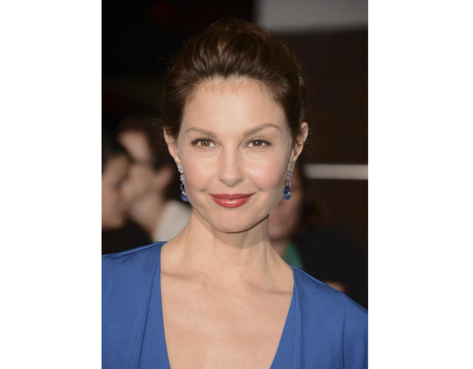 CORRECTS SPELLING OF JUDGES NAME TO PHILIP - FILE - In this March 18, 2014 file photo, Ashley Judd arrives at the world premiere of "Divergent" in Los Angeles. A federal judge has thrown out part of a lawsuit Judd filed against Harvey Weinstein that alleges he deliberately derailed her career when she turned him down sexually. U.S. District Judge Philip S. Gutierrez on Wednesday, Sept. 19, 2018, dismissed the sexual harassment allegation in the lawsuit, ruling that the California law Judd was suing under does not apply to the professional relationship she and the movie mogul had at the time. (Photo by Jordan Strauss/Invision/AP, File)