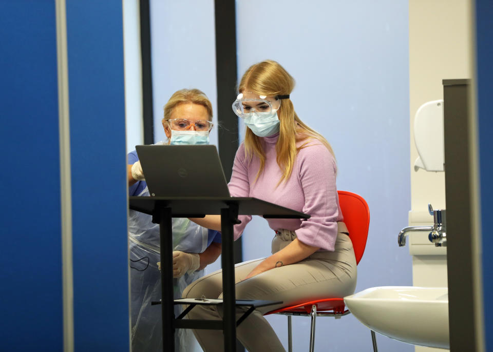 Nurses prepare for COVID vaccinations at a centre in Wakefield on Tuesday. The majority of jabs so far have gone to people in the top priority groups, though there have been some reports of younger people receiving leftover doses. (Danny Lawson/PA)