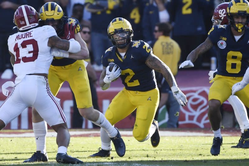 Former Michigan Wolverines playmaker Blake Corum (C) is among the top running back prospects still available for selection in the 2024 NFL Draft. File Photo by Jon SooHoo/UPI