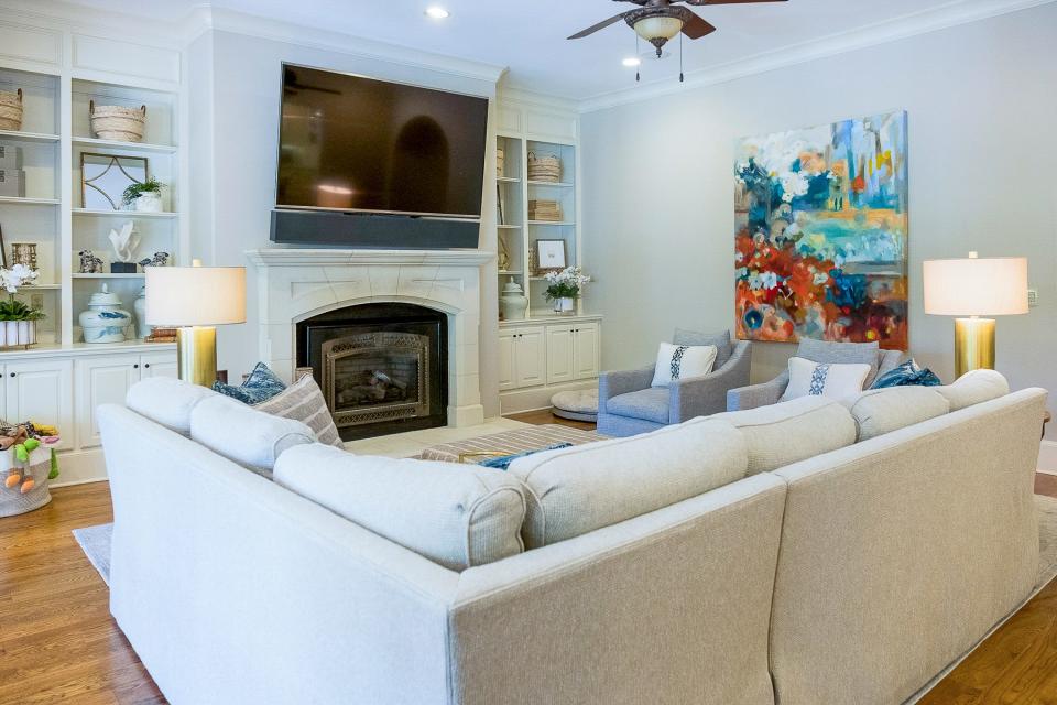 The TV room has plenty of seating, a large flatscreen TV and a working fireplace.