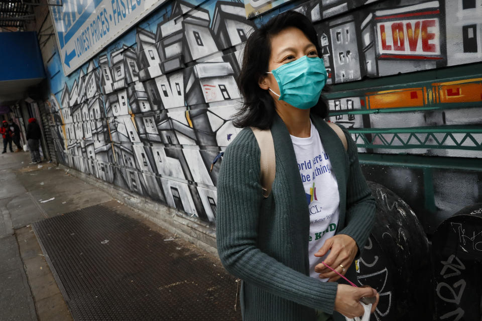 Dr. Jeanie Tse, chief medical officer at the Institute for Community Living, walks along a graffiti mural during her rounds treating psychiatric patients, Wednesday, May 6, 2020, in the Brooklyn borough of New York. (AP Photo/John Minchillo)