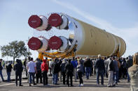 Employees and contractors watch as the core stage of NASA's Space Launch System rocket, that will be used for the Artemis 1 Mission, is moved to the Pegasus barge, at the NASA Michoud Assembly Facility where it was built, in New Orleans, Wednesday, Jan. 8, 2020. It will be transported to NASA's Stennis Space Center in Mississippi for its green run test. (AP Photo/Gerald Herbert)