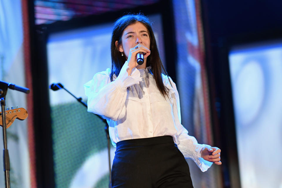 A closeup of Lorde performing