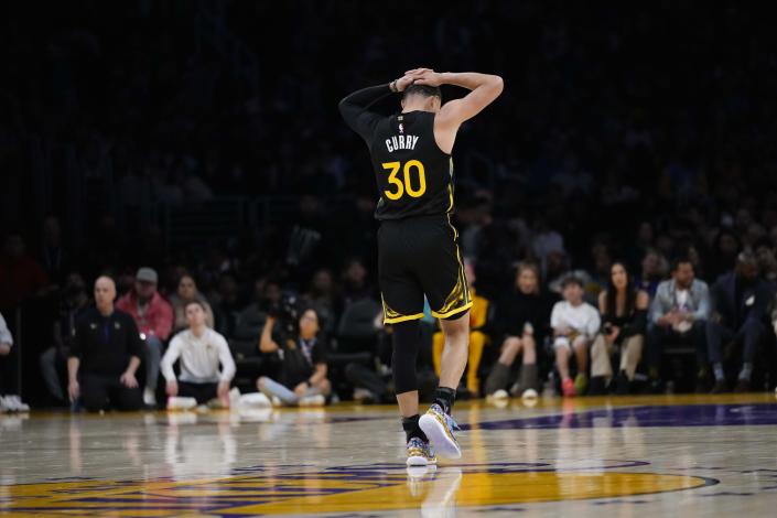 Golden State Warriors' Stephen Curry (30) reacts to a foul call on him during the first half of an NBA basketball game against the Los Angeles Lakers, Sunday, March 5, 2023, in Los Angeles. (AP Photo/Jae C. Hong)