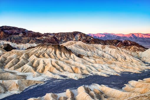 badlands view from zabriskie point in death valley national park at sunset, california