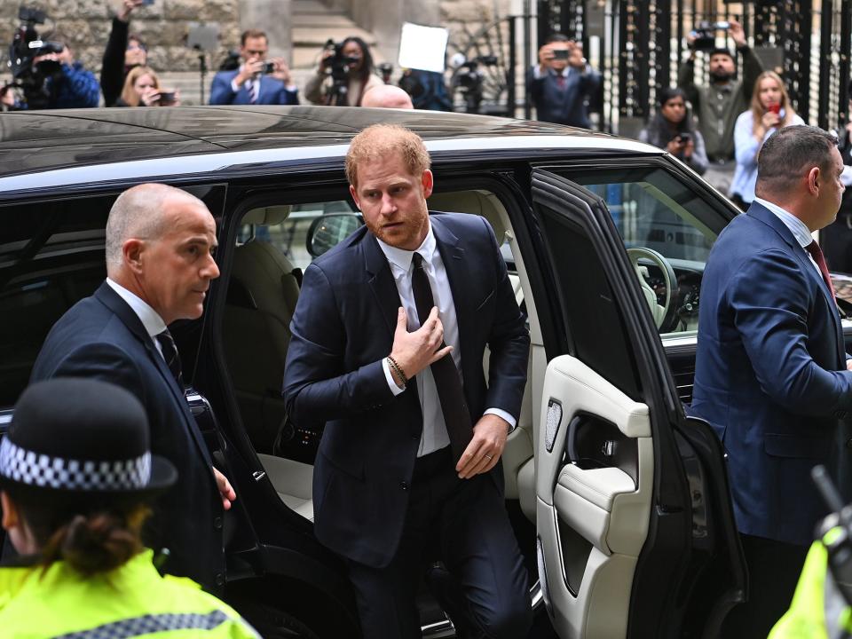 Harry arrived outside the Rolls Building in central London at 9.36am in a black Range Rover, wearing a black suit (EPA)