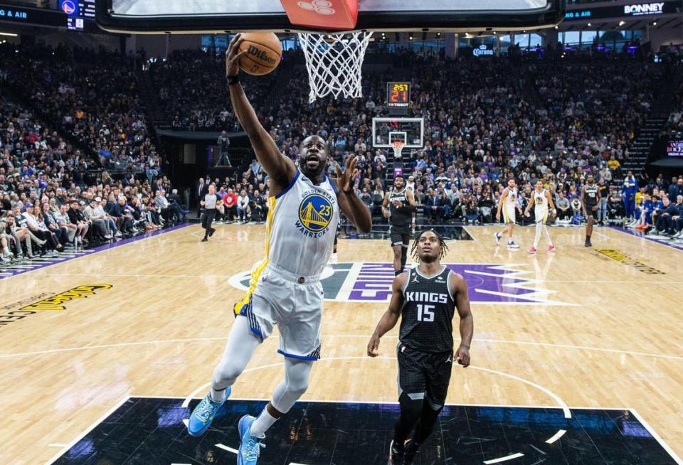 Golden State Warriors forward Draymond Green (23) drives to the basket after a steal as Sacramento Kings guard Davion Mitchell (15) watches on April 7 at Golden 1 Center.