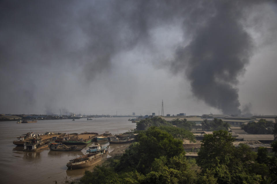 Black smoke billows from the industrial zone of Hlaing Thar Yar township in Yangon, Myanmar Sunday, March 14, 2021. Attacks on Chinese-run factories in Myanmar's biggest city drew demands Monday from Beijing for protection for their property and employees, while many in Myanmar expressed outrage over China's apparent lack of concern for those killed in protests against last month's military coup. Myanmar state media have reported that martial law was declared in six districts in Yangon, including the major industrial zones of Hlaing Thar Yar and Shwepyitha. (AP Photo)