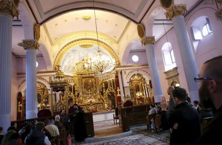 Armenian priest Vagarsag Seropyan gives information to visitors at the Surp Asdvadzadzin Patriarchal Church in Istanbul April 23, 2015. REUTERS/Murad Sezer