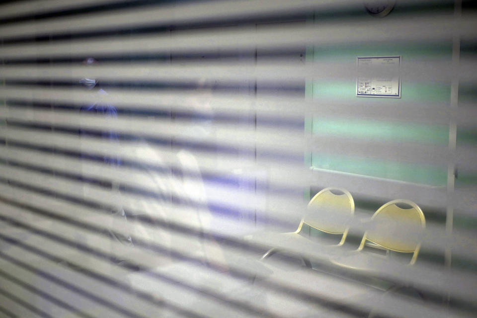 A patient walks on a corridor at the emergency ward of the Rouvray psychiatric hospital, in Rouen, western France, Wednesday, Nov. 25, 2020. Lockdowns that France has used to fight the coronavirus have come at considerable cost to mental health. Surveying points to a surge of depression most acute among people without work, in financial hardship and young adults. (AP Photo/Thibault Camus)