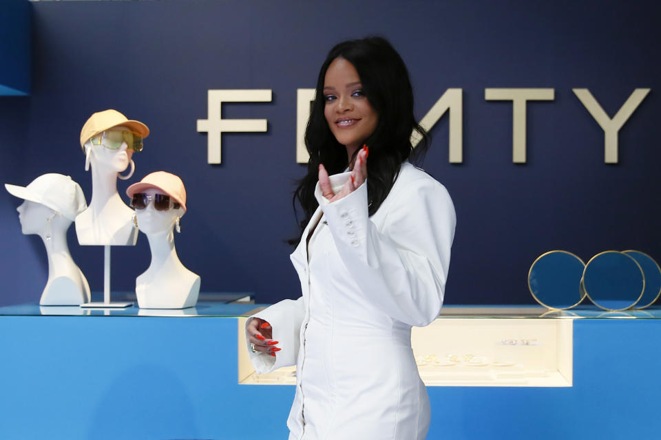 Singer Rihanna, the first black woman in history to head up a major Parisian luxury house, poses as she unveiled her first fashion designs for Fenty at a pop-up store in Paris, France, Wednesday, May 22, 2019. The collection, named after the singer turned designer's last name, comprises ready-to-wear, footwear, accessories, and eyewear and is available for sale Paris' Le Marais area from Friday and will debut online May 29. (AP Photo/Francois Mori)