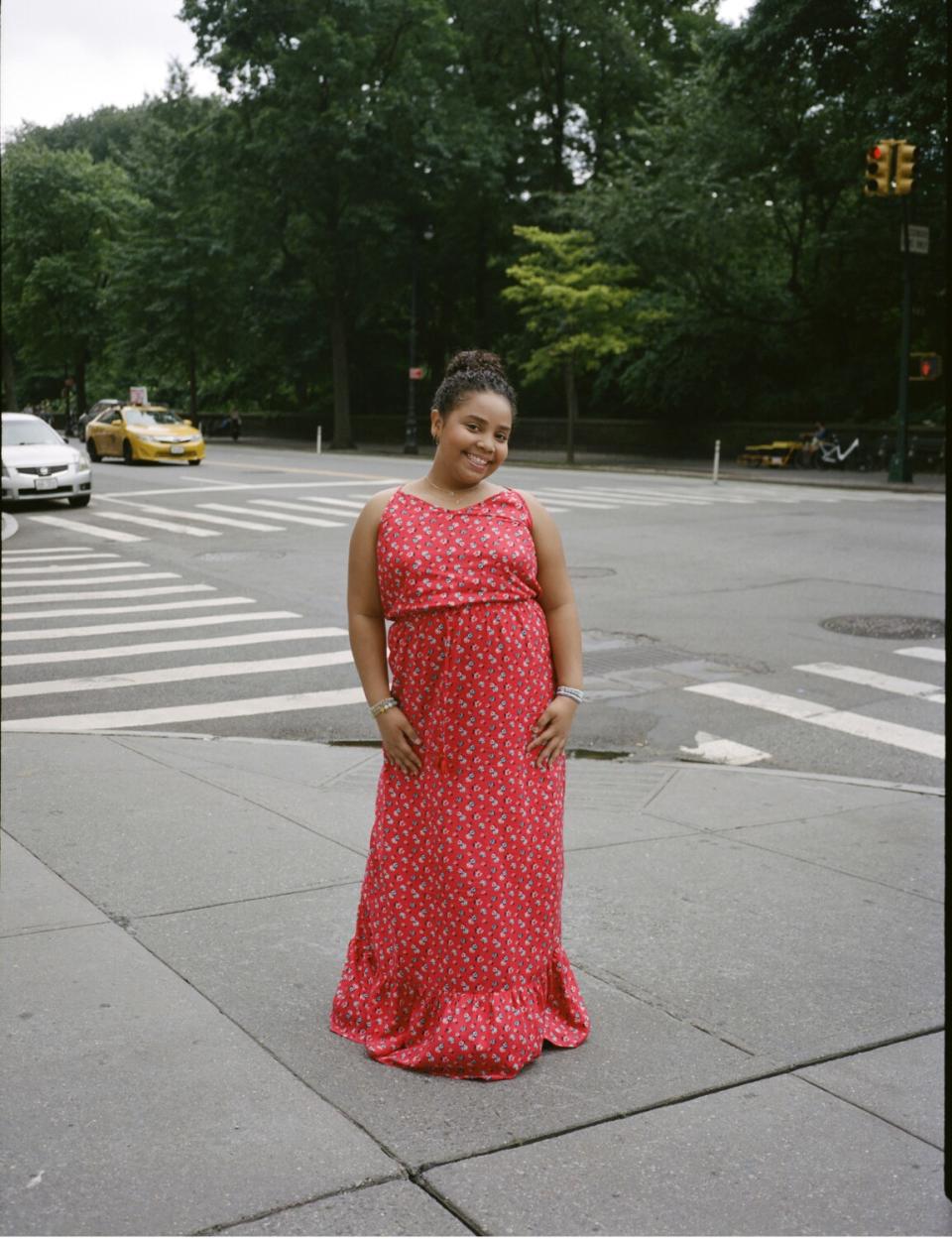 A young girl standing on a New York City sidewalk