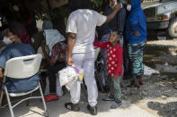 Haitian migrants deported from the US, gather after arriving at the Toussaint Louverture International Airport in Port-au-Prince, Haiti, Sunday, Sept. 19, 2021. Thousands of Haitian migrants have been arriving to Del Rio, Texas, to ask for asylum in the U.S., as authorities begin to deported them to back to Haiti. (AP Photo/Rodrigo Abd)