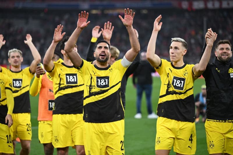 Dortmund players cheer after the German Bundesliga soccer match between Bayern Munich and Borussia Dortmund at the Allianz Arena. Sven Hoppe/dpa