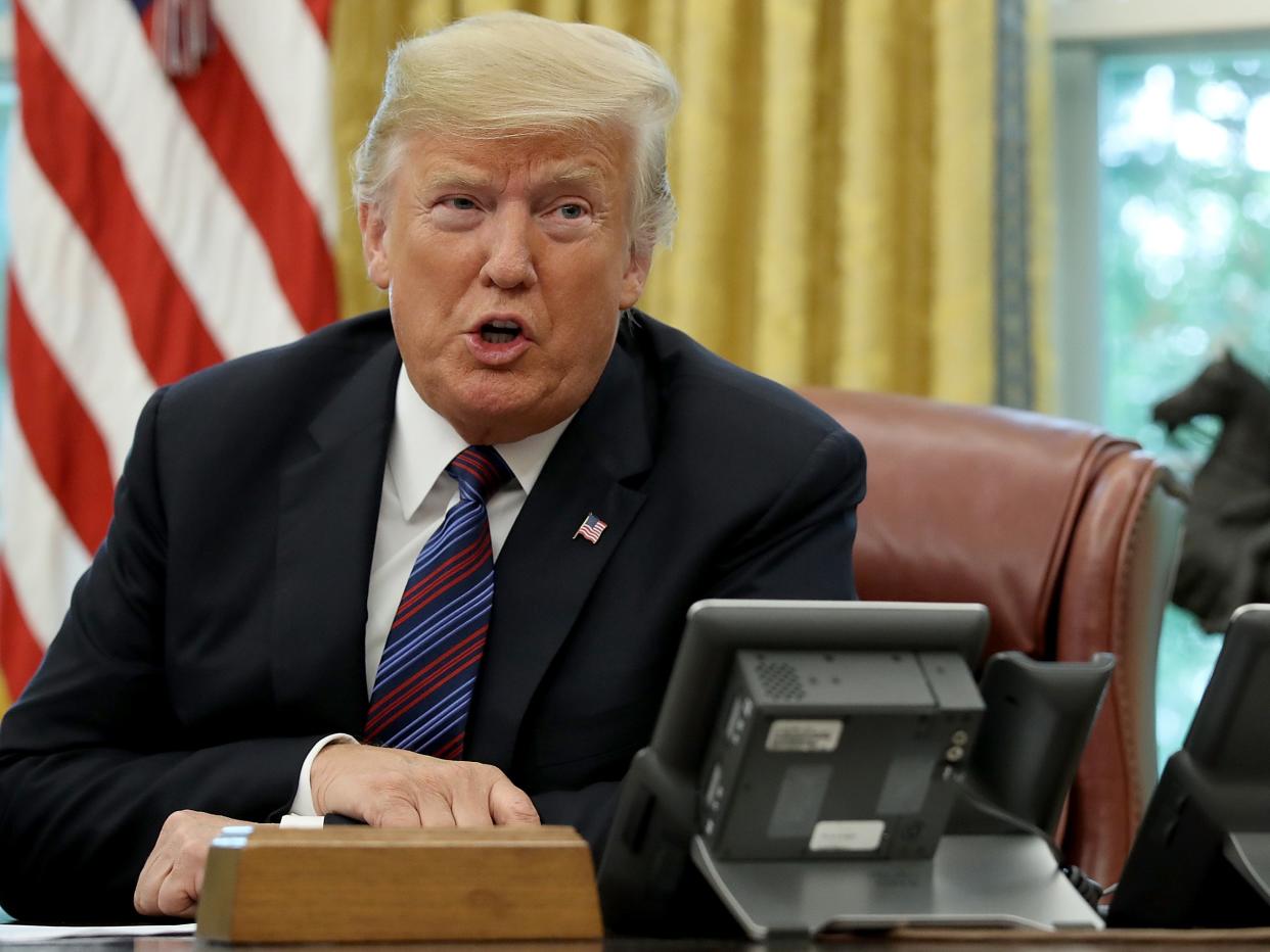 <p>Donald Trump speaks on the telephone via speakerphone with Mexican President Enrique Peña Nieto in the Oval Office of the White House on 27 August 2018 in Washington, DC</p> ((Getty Images))