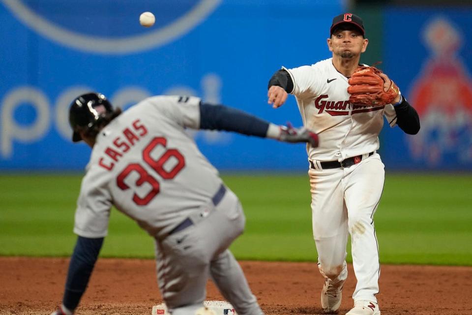 Cleveland Guardians second baseman Andres Gimenez throws to first after forcing out Triston Casas (36) on a double play hit into by Rob Refsnyder during the eighth inning of a baseball game Thursday, June 8, 2023, in Cleveland. (AP Photo/Sue Ogrocki)