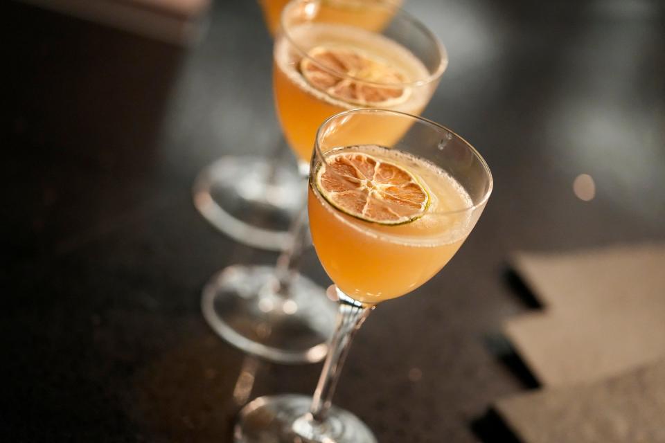 A cocktail made with Rum Bar Gold, Probitas Rum, banana cardamom demerara, lemon and lime is served Wednesday, Jan. 17, 2024, during a preview event for Commission Row, a new restaurant, bar and event space near Gainbridge Fieldhouse in downtown Indianapolis.
