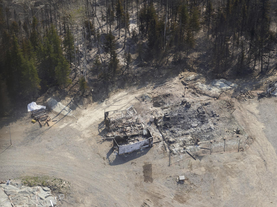 A cottage destroyed by wildfires burning in northern Manitoba, Canada, as seen from a helicopter on Tuesday, May 14, 2024. (David Lipnowski/The Canadian Press via AP)