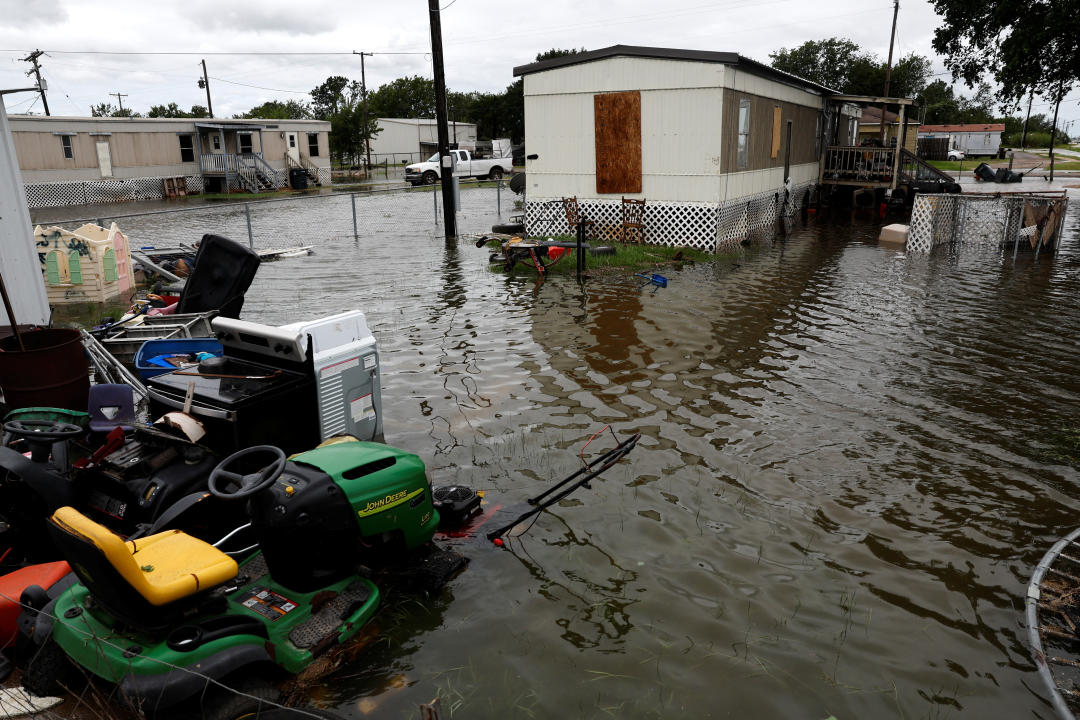 A flooded street lined with mobile homes in El Campo, Texas.