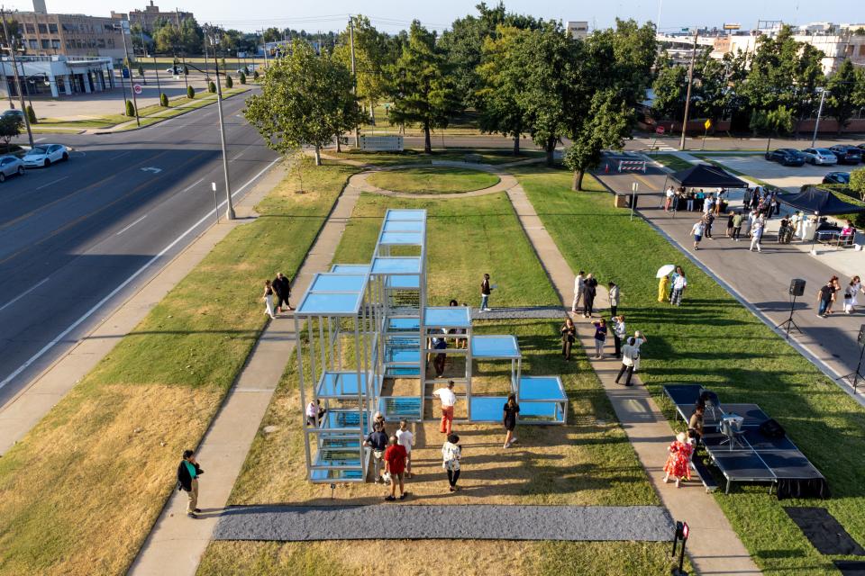 People are seen on Aug. 31 walking around and through Eva Schlegel’s public sculpture "Multiple Voices" at Campbell Art Park outside Oklahoma Contemporary Arts Center in Oklahoma City.