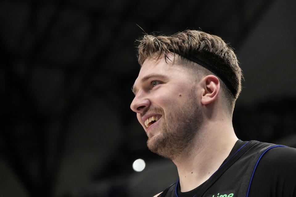 Dallas Mavericks guard Luka Doncic smiles after sinking a three-point basket in the first half of an NBA basketball game against the Phoenix Suns in Dallas, Wednesday, Jan. 24, 2024. (AP Photo/Tony Gutierrez)