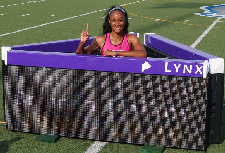 Brianna Rollins poses with the sign board after setting a new American Record of 12.26 seconds in the Women's 100 Meter Hurdles final on day three of the 2013 USA Outdoor Track & Field Championships at Drake Stadium on June 22, 2013 in Des Moines, Iowa. Rollins served notice she is a force to be reckoned with by matching the fourth-fastest 100m hurdles time in history