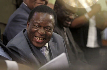 FILE PHOTO: Zimbabwe Vice-President Emmerson Mnangagwa listens as President Robert Mugabe delivers his state of the nation address to the country's parliament in Harare, Zimbabwe August 25, 2015. Picture taken August 25, 2015. REUTERS/Philimon Bulawayo