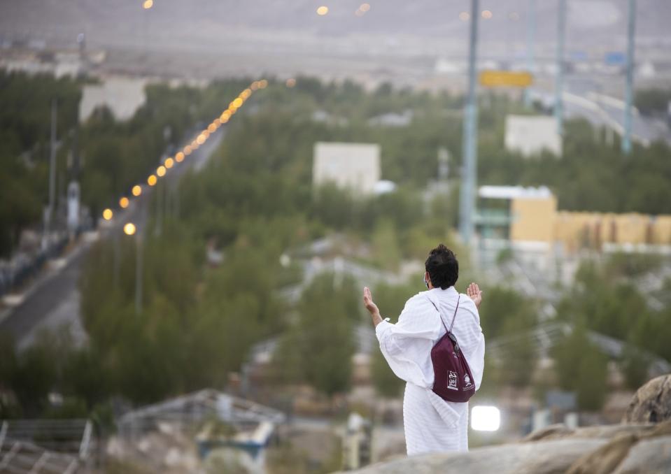 Muslim pilgrims pray on top of the rocky hill known as Mountain of Mercy on the Plain of Arafat.