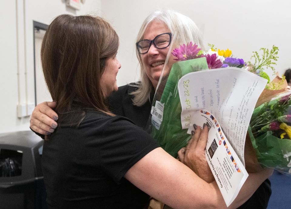 San Joaquin County Office of Education's Assistant Superintendent of Education Services Jane Steinkamp, right, is hugged by Annie Cunial, division director for STEM programs, after Steinkamp was surprised with the announcement that she was the recipient of the 2022 ATHENA Award.