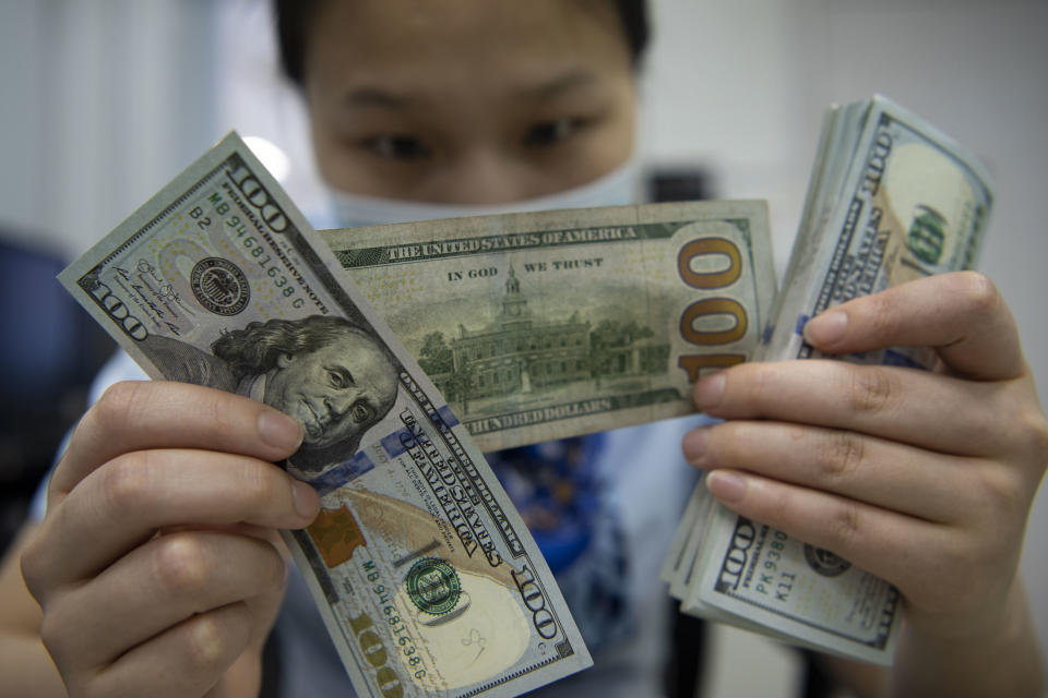 A staff member counts U.S. dollar notes at a bank, June 16, 2022. (Photo credit should read CFOTO/Future Publishing via Getty Images)