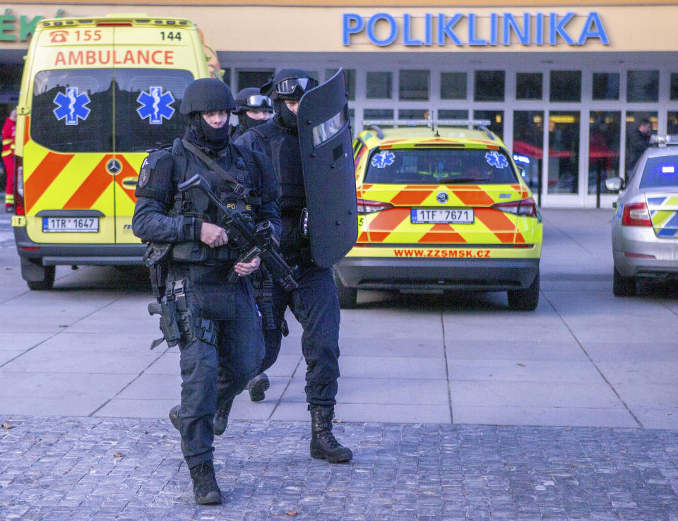 Police personnel outside the Ostrava Teaching Hospital after a shooting incident in Ostrava, Czech Republic, Tuesday, Dec. 10, 2019. Police and officials say six people have been killed and two people injured in a shooting in a hospital in the eastern Czech Republic. (Vladimir Prycek/CTK via AP)