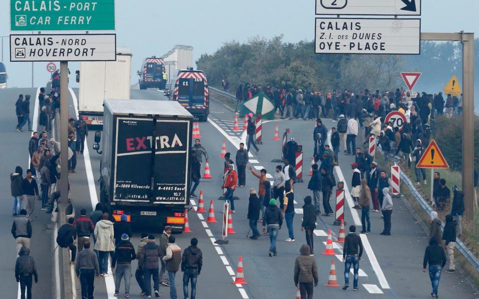 migrants and lorries - Credit: Reuters