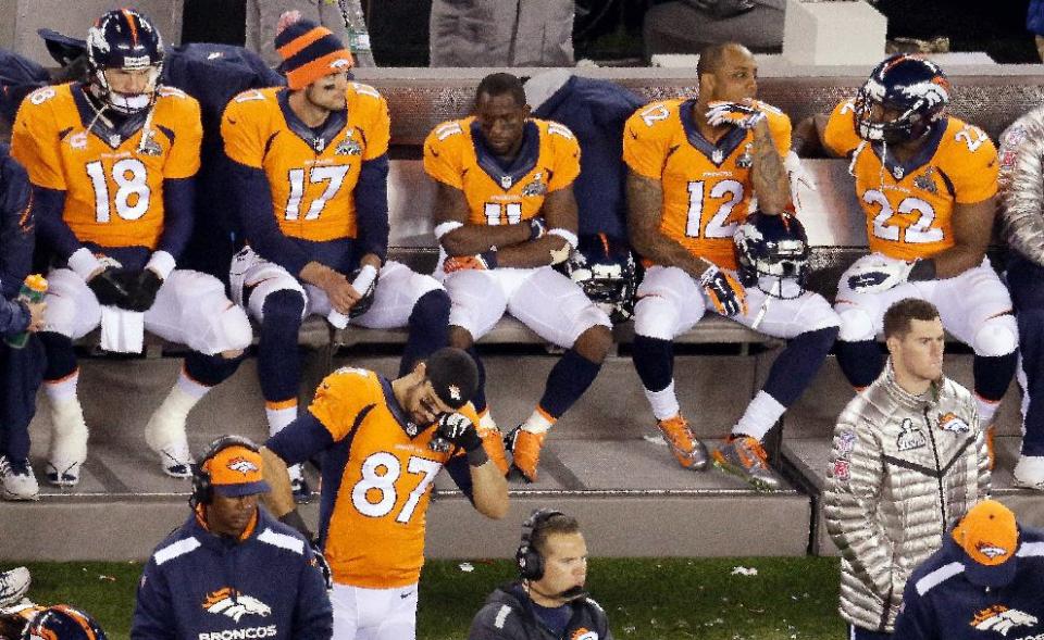 Denver Broncos' Peyton Manning sits with teammates late in the second half of the NFL Super Bowl XLVIII football game against the Seattle Seahawks, Sunday, Feb. 2, 2014, in East Rutherford, N.J. The Seattle Seahawks won 43-8. (AP Photo/Mel Evans)